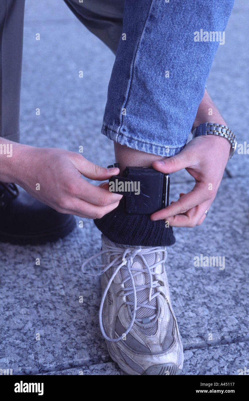 Electronic monitoring device being fitted around ankle Nebraska USA Stock Photo Alamy