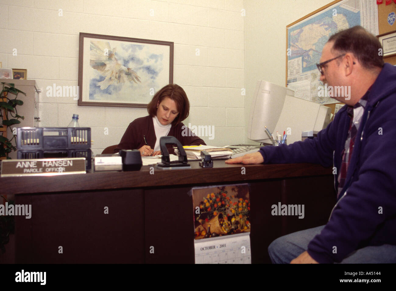 Parole officer at desk meeting with parolee Stock Photo