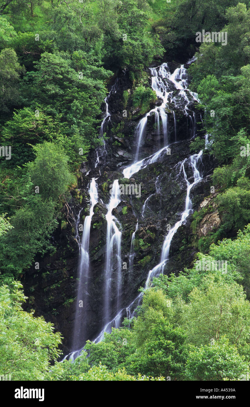 Waterfall among leafy trees and rock in the Scottish highlands in scotland Stock Photo