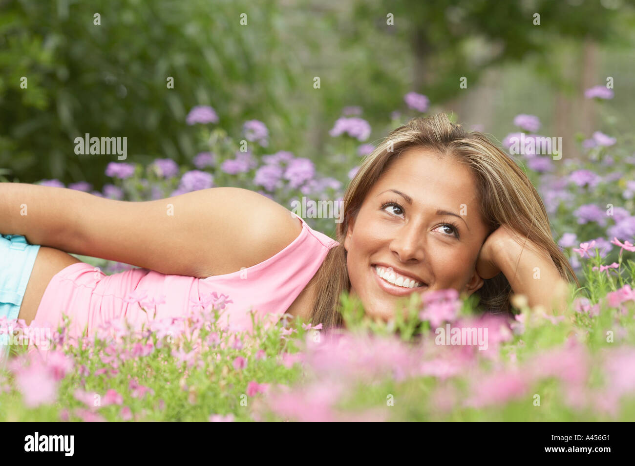 Young woman lying on the grass Stock Photo - Alamy