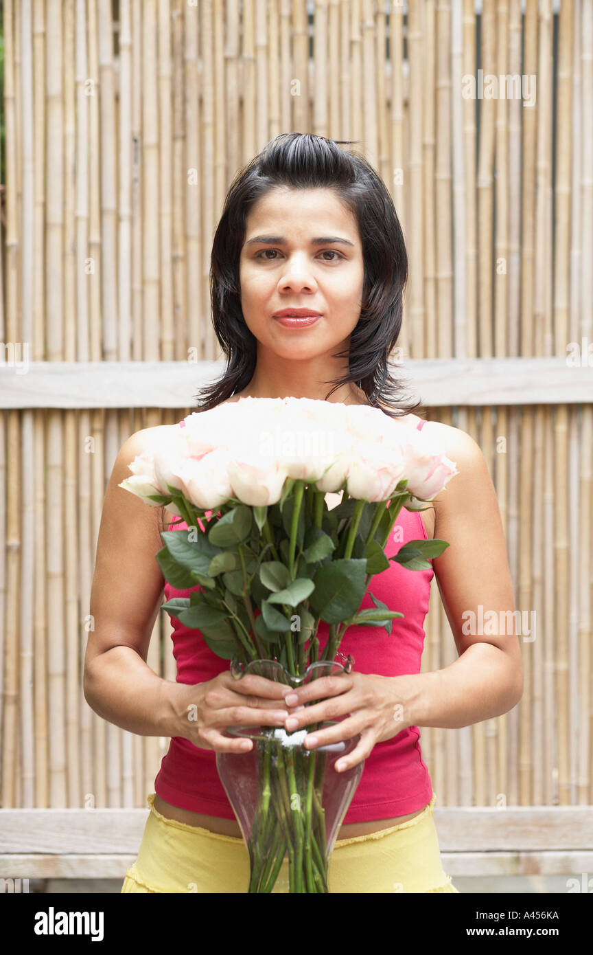 Portrait of woman holding flower arrangement Stock Photo - Alamy