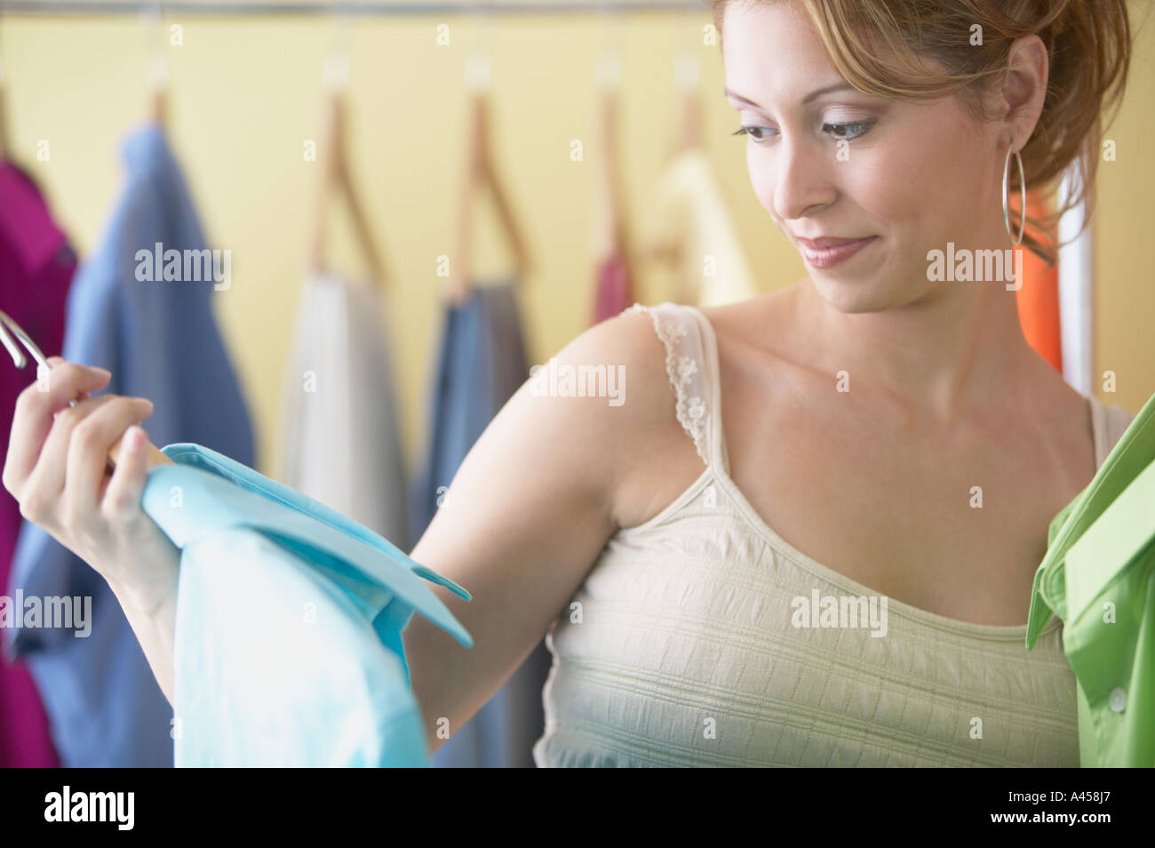 Hispanic women looking at men s clothes in boutique Stock Photo