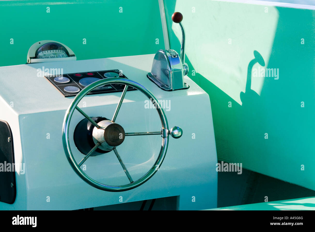 Old fishing boat cockpit with spoke steering wheel Stock Photo Alamy