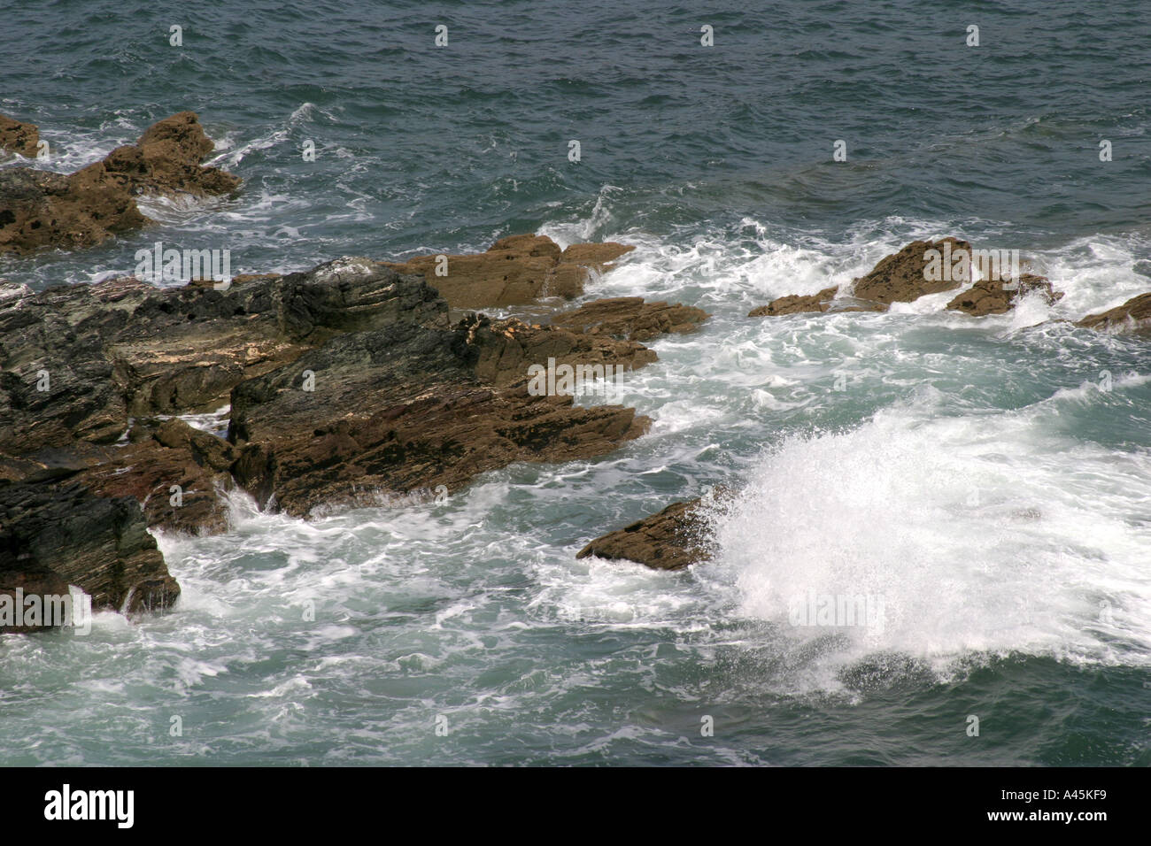 Waves breaking on rocks Stock Photo - Alamy