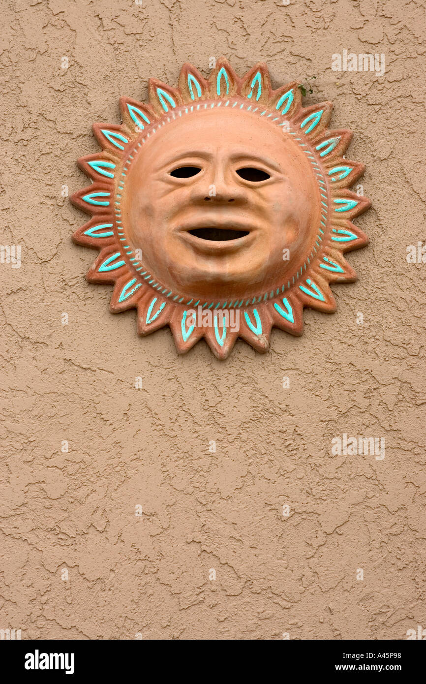 A terra cotta of the sun adorns a wall in Mesilla a popular touristic destination in New Mexico