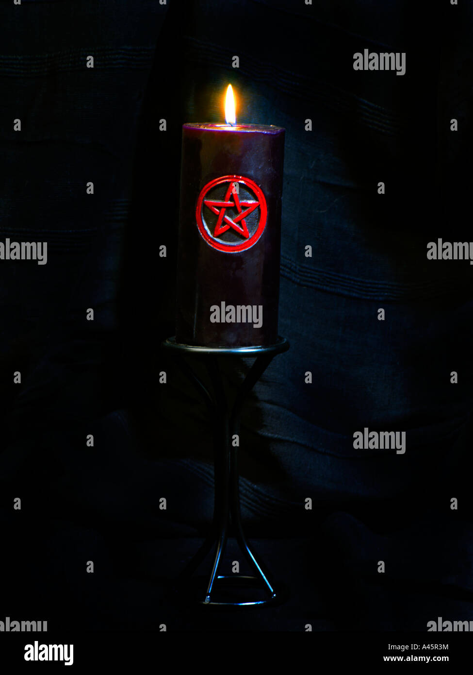 Red Pentacle with Black Candle Stock Photo