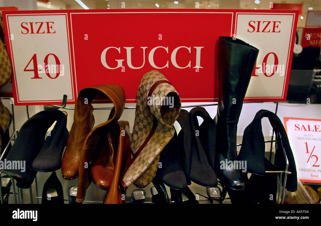 a rack of gucci designer shoes and boots at the harrods sale Stock Photo -  Alamy
