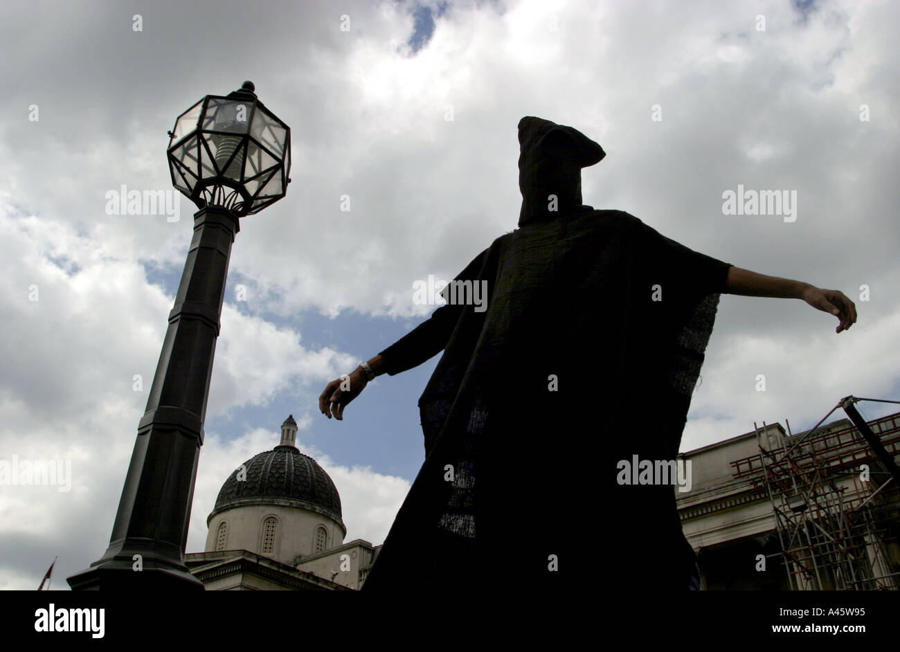 a protester poses as an abused abu ghreib prison inmate during a demonstration in london against the israeli governments building of a security wall around the west bank and gaza and the ongoing us and british occupation of iraq 15 may 2004 Stock Photo