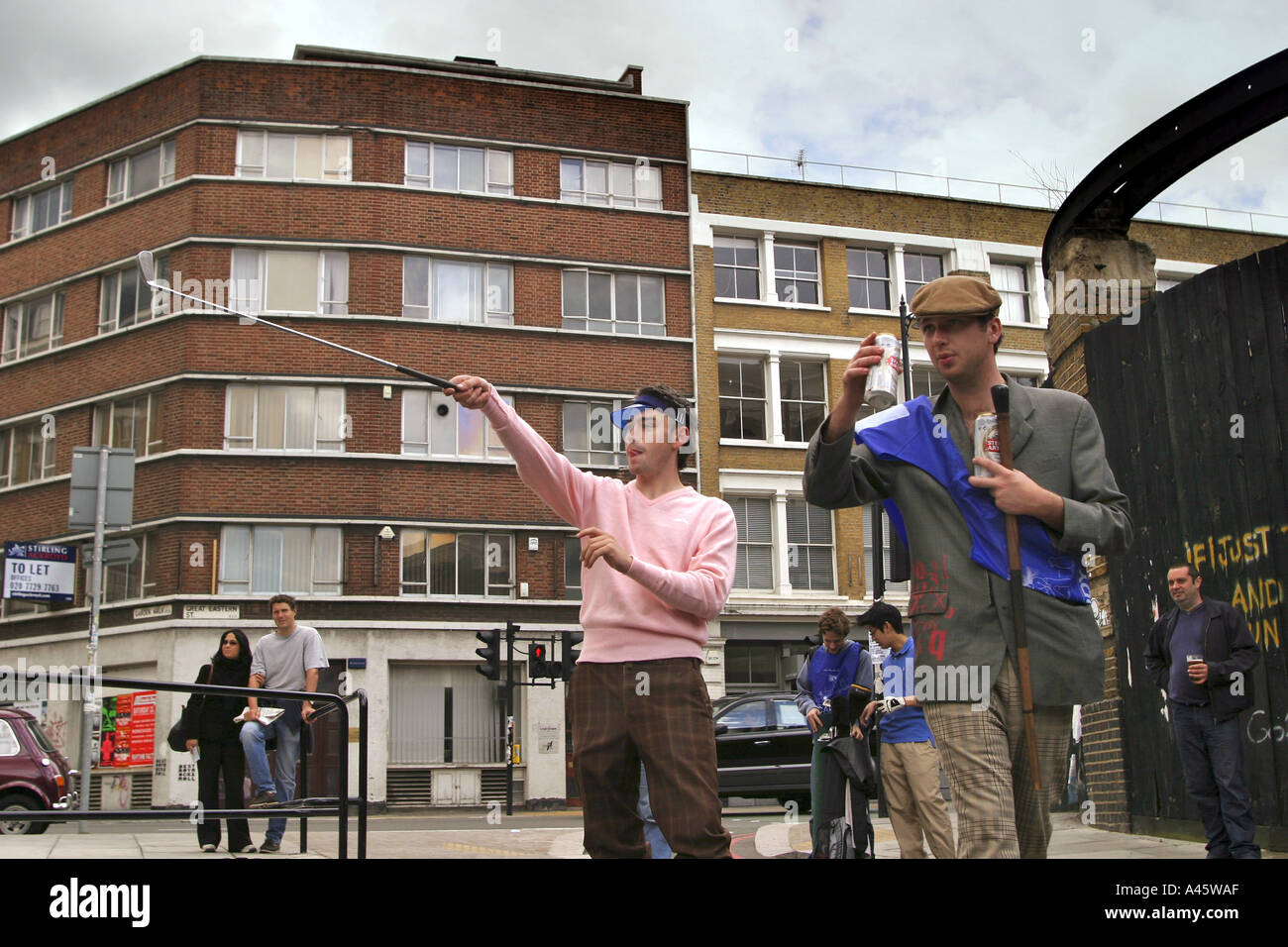 urban golf competitors look for the ball at the first shoreditch urban open tournament in london the ball is a beanbag ensuring safety in the street Stock Photo