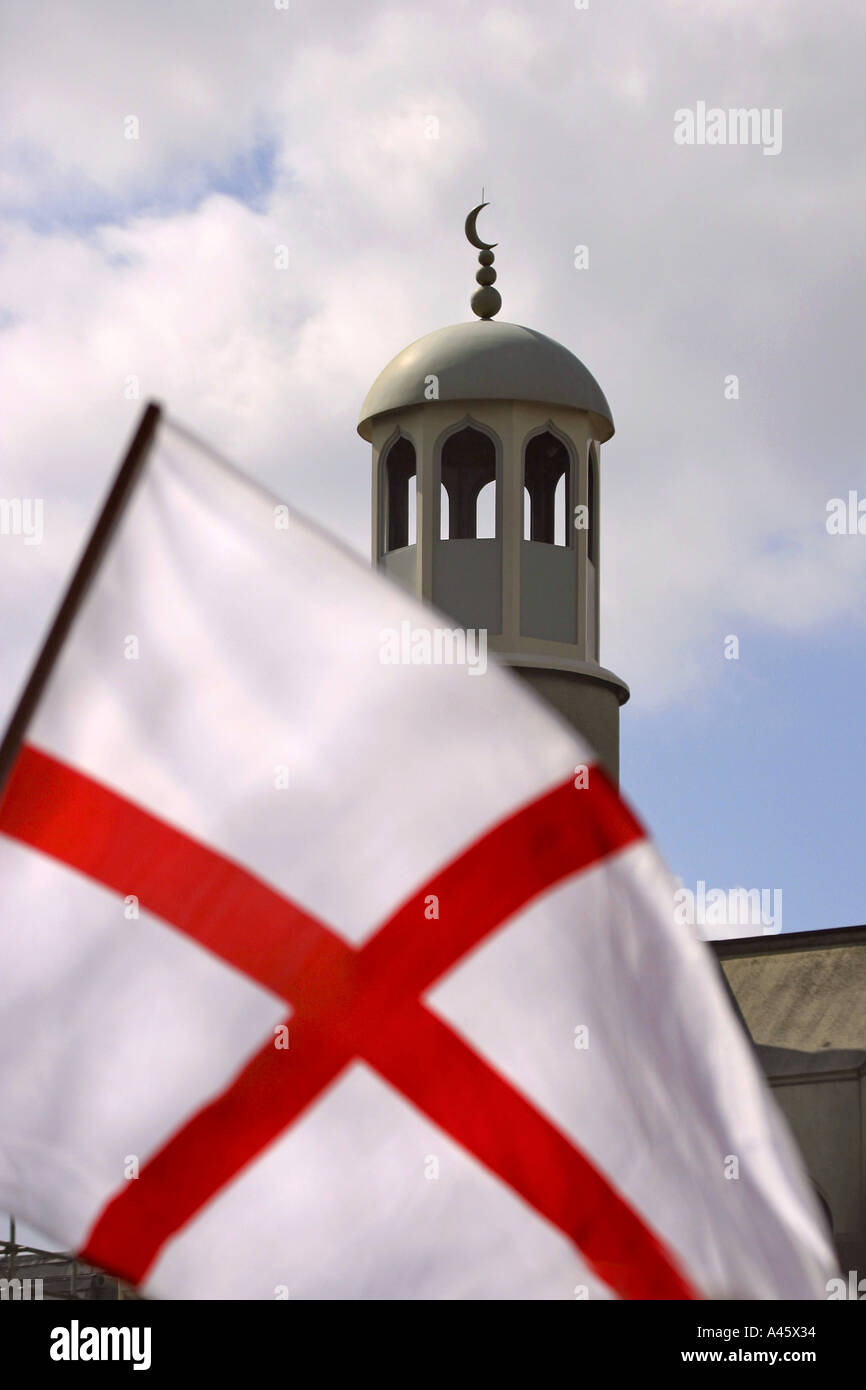 an english flag of st george is waved during a demonstration by the neo fascist national front party as they picket finsbury park mosque in london april 2004 Stock Photo