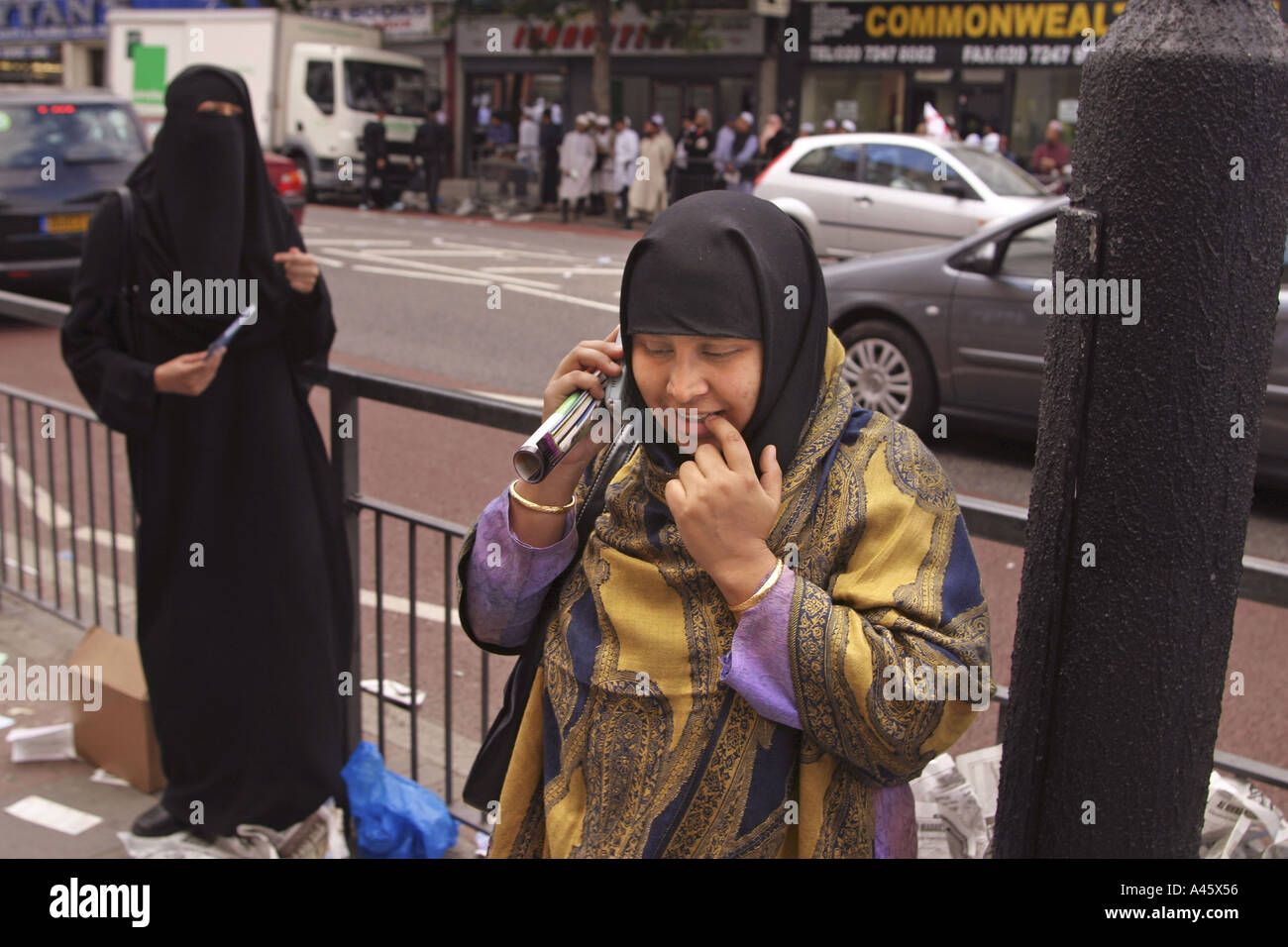 a muslim woman talks on a mobile telephone outside the east london mosque in whitechapel in the east end of london Stock Photo