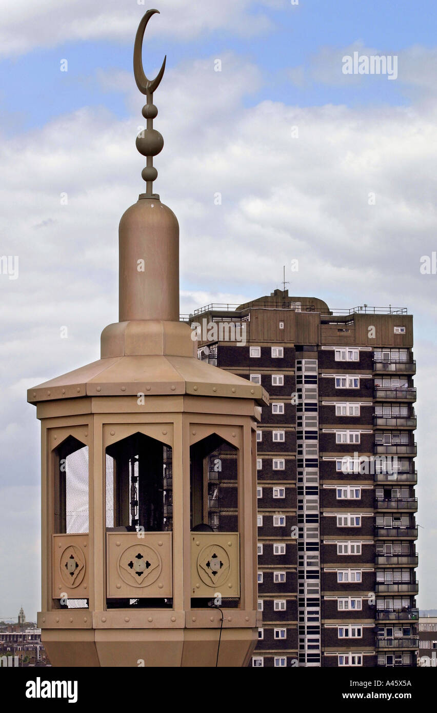 the minaret of the east london mosque is viewed near a tower block in whitechapel high street in the east end of london Stock Photo