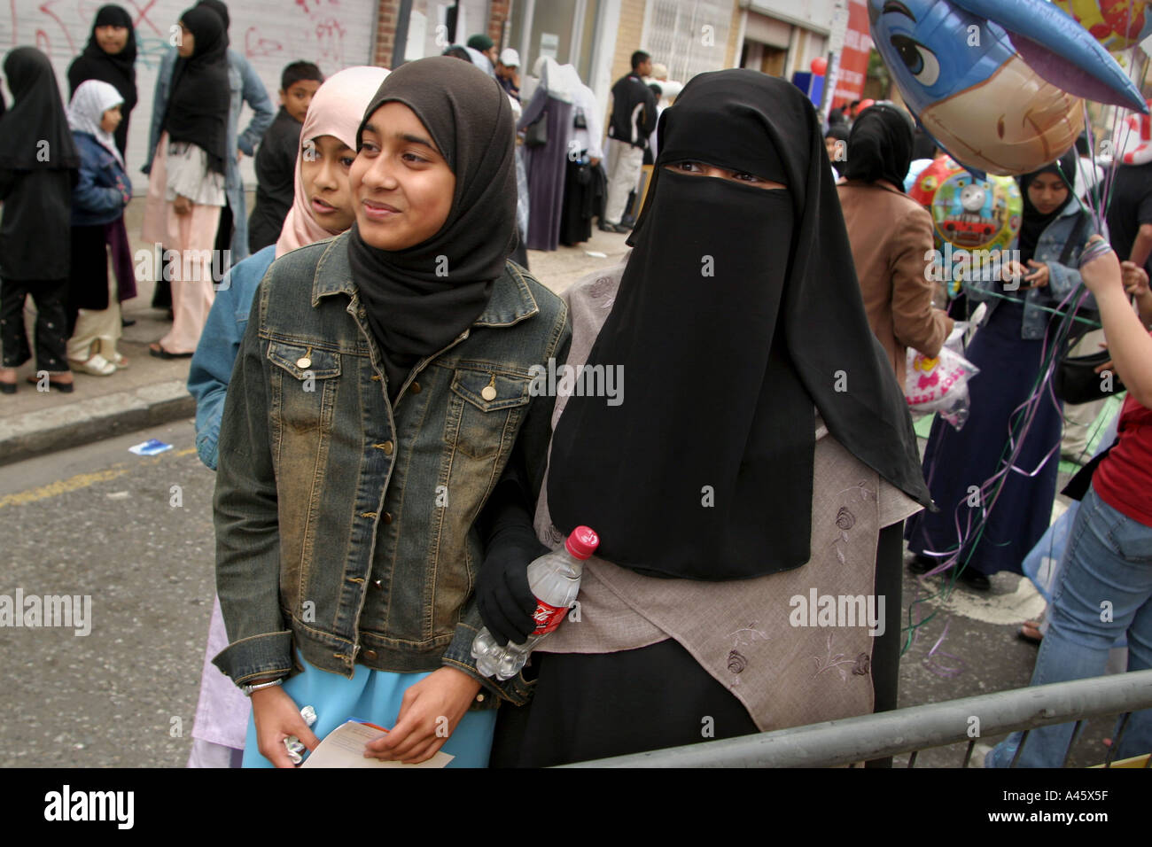 muslim girls wearing the hijab headscarf and veil at a fair to open the new london muslim centre an annex to the east london mosque in whitechapel in the east end of london Stock Photo