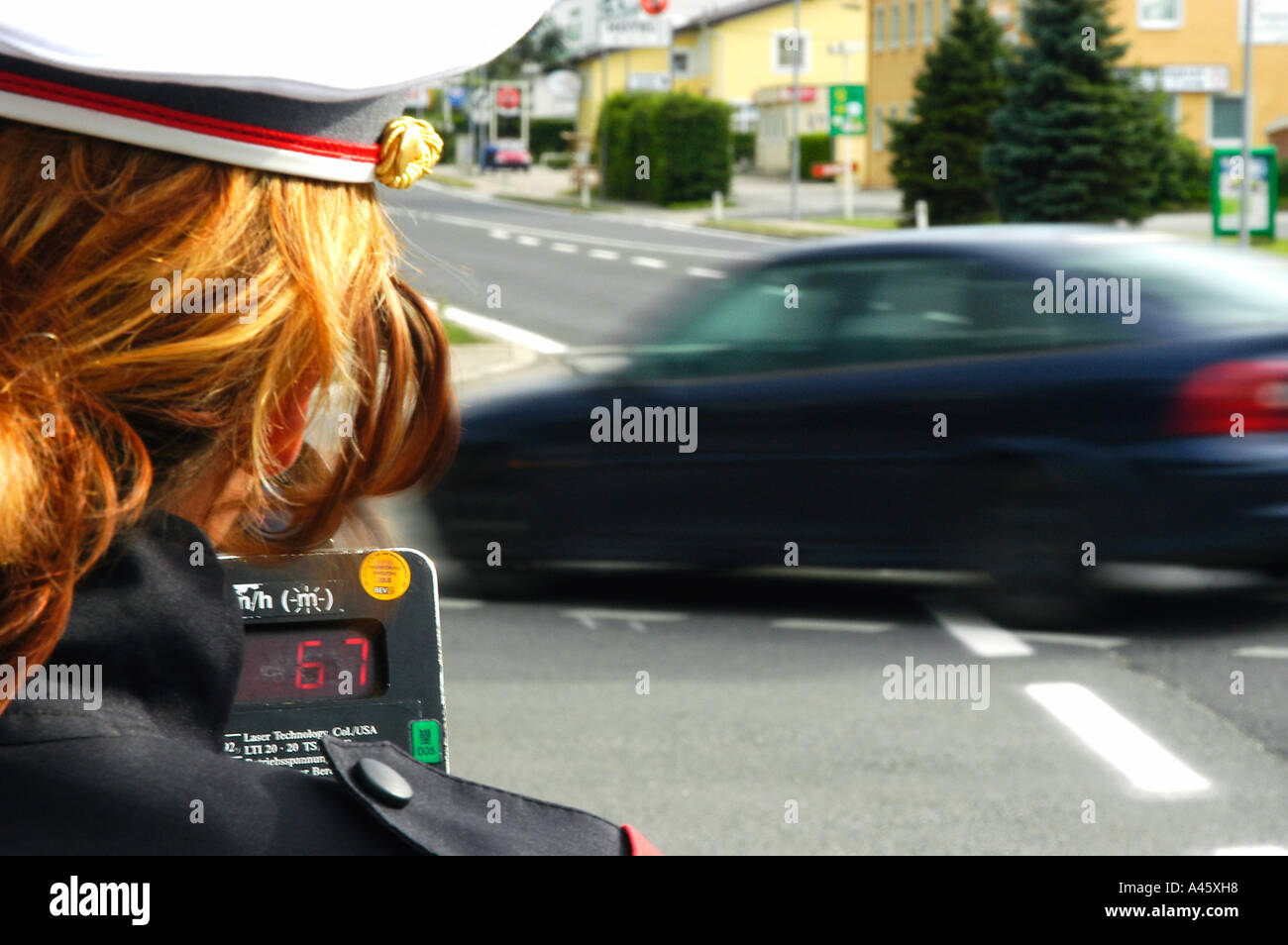 A Police Officer measuring speed with a Laser Gun Stock Photo Alamy