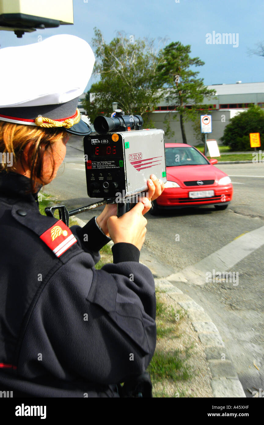 A Police Officer measuring speed with a Laser Gun Stock Photo Alamy