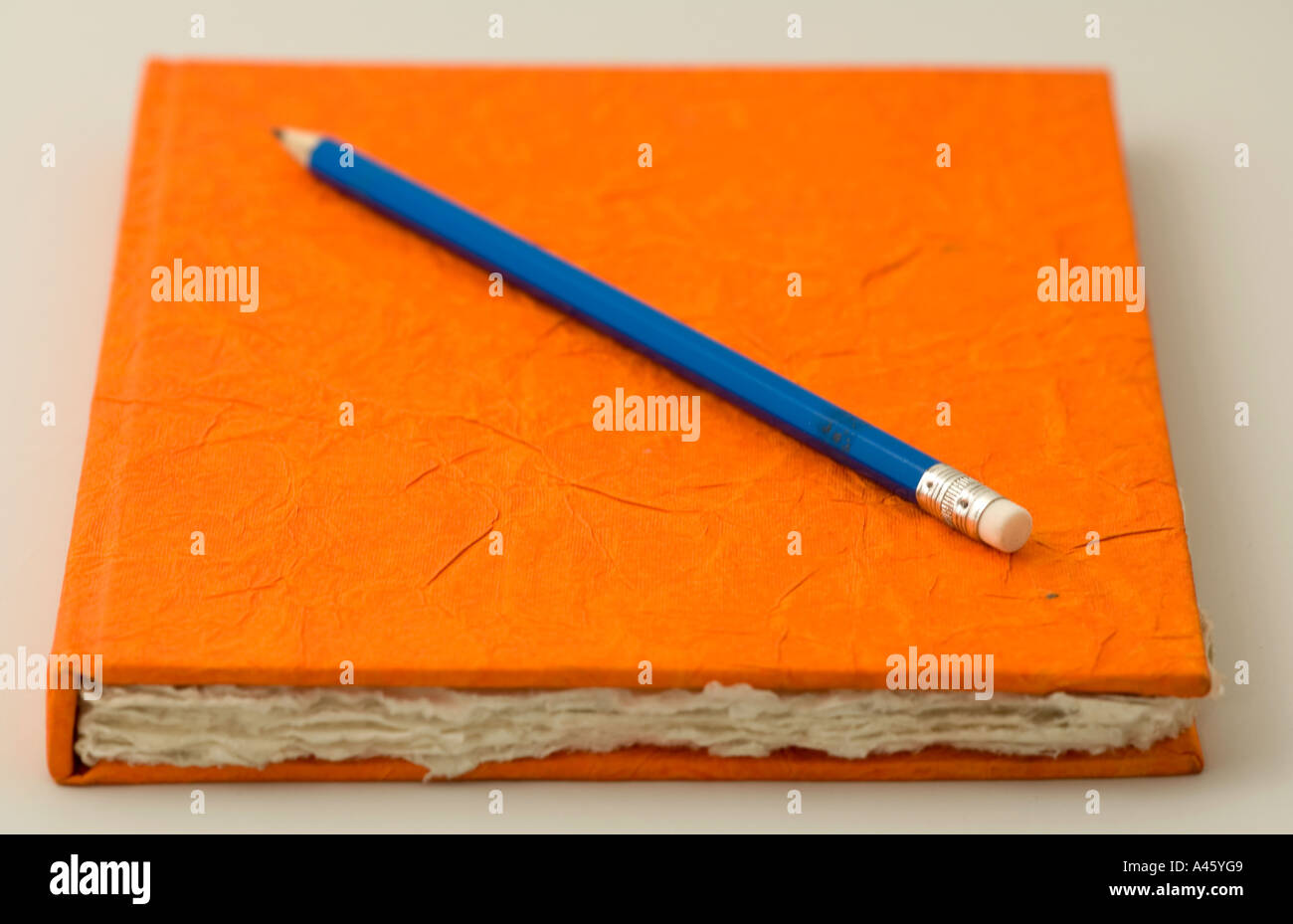 Orange scrapbook and pencil Stock Photo