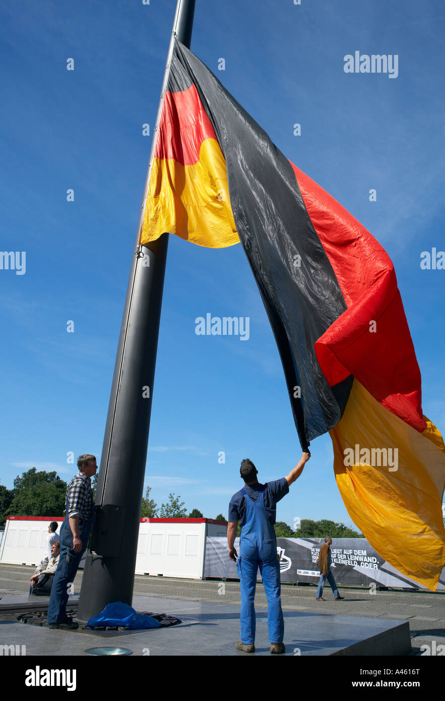 Raising of a big German national flag in front of the Reichstag, Berlin, Germany Stock Photo