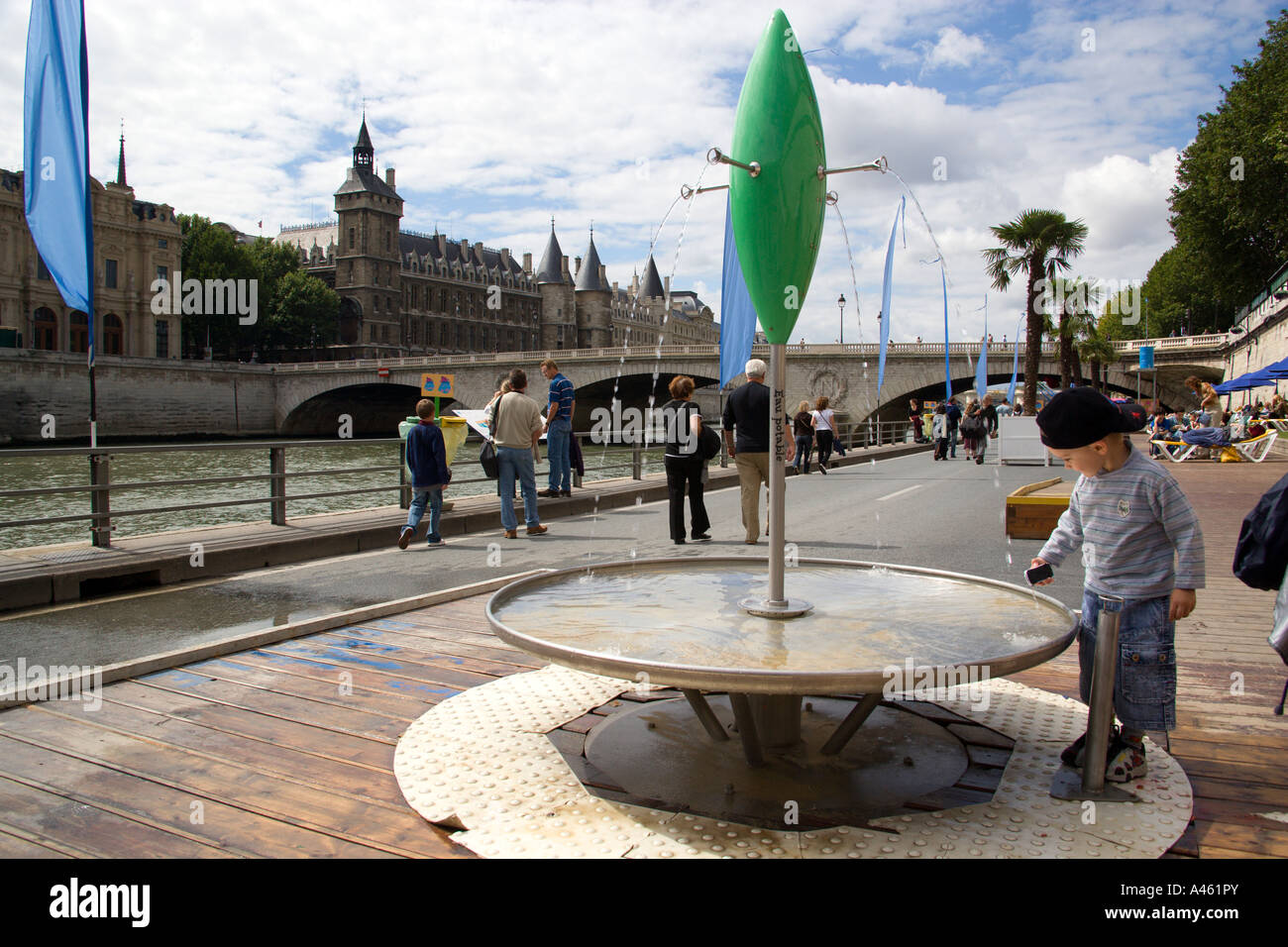 FRANCE Ile de France Paris The Paris Plage urban beach. Boy drinking potable water from one of
