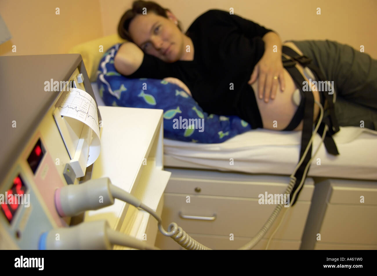 Pregnant woman with heartmonitor to monitor the babys heartbeat Stock Photo