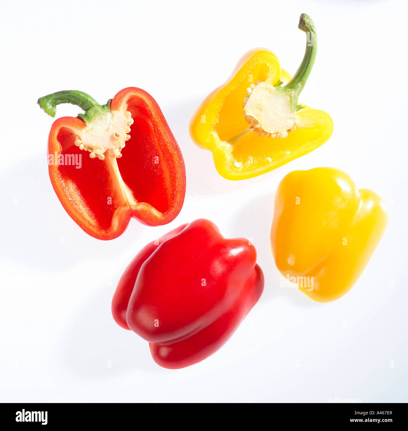 Red and yellow bell peppers on a white background Stock Photo - Alamy