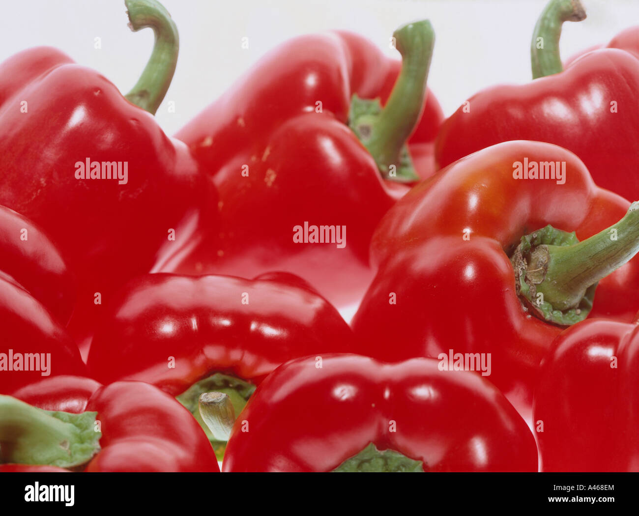Red bell peppers on a white background Stock Photo - Alamy