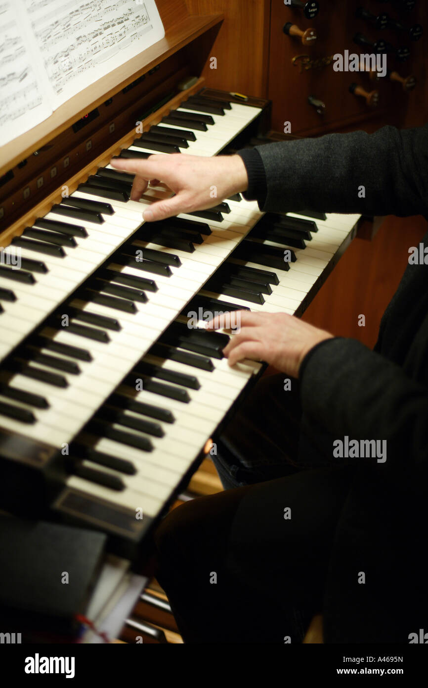 Organist at church organ Stock Photo