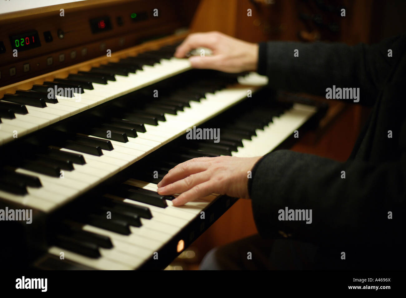 Organist at church organ Stock Photo