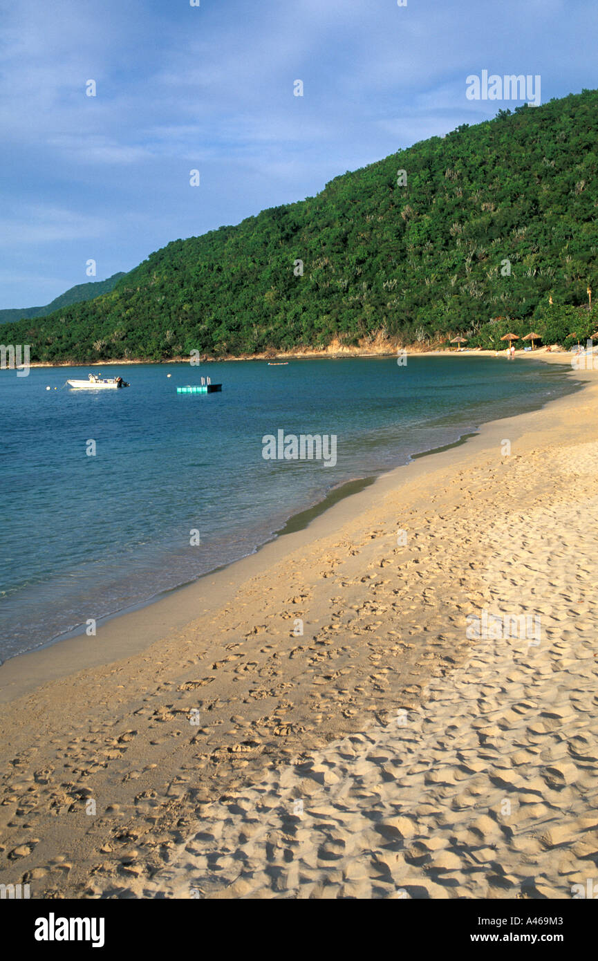 British Virgin Islands BVI Virgin Gorda Little Dix Bay deserted  beach footsteps fishing boats background seascape Stock Photo