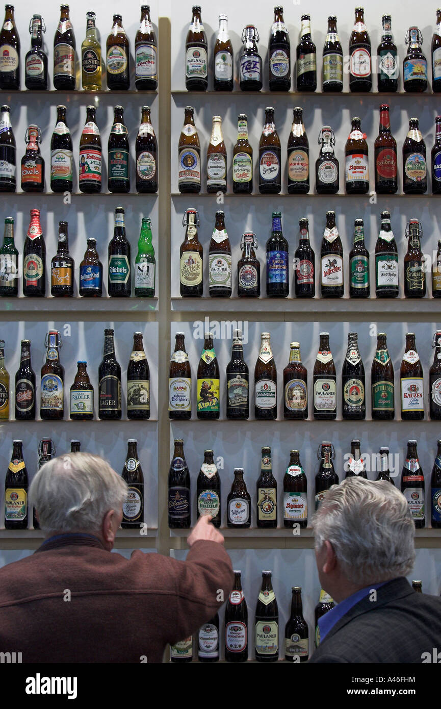 Two elderly men looking at beer bottles on shelves Stock Photo Alamy