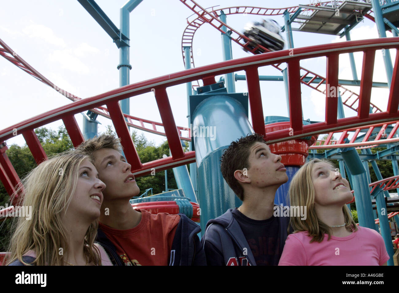 Teenage visitors in a queue for the spinball whizzer ride at Alton