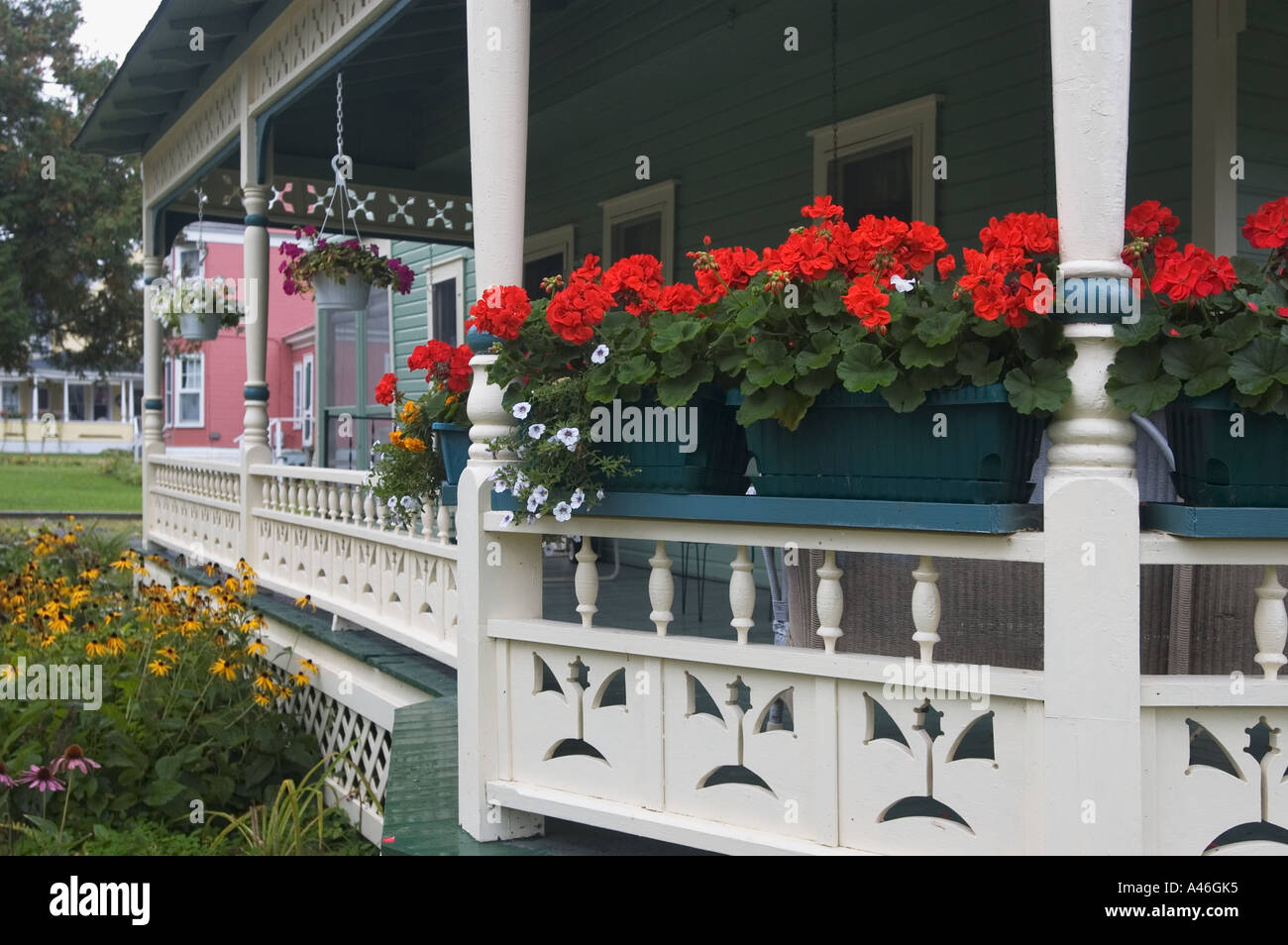 Geraniums Other Flowers On Porch Of Victorian Home Thousand Island Park New York Stock Photo