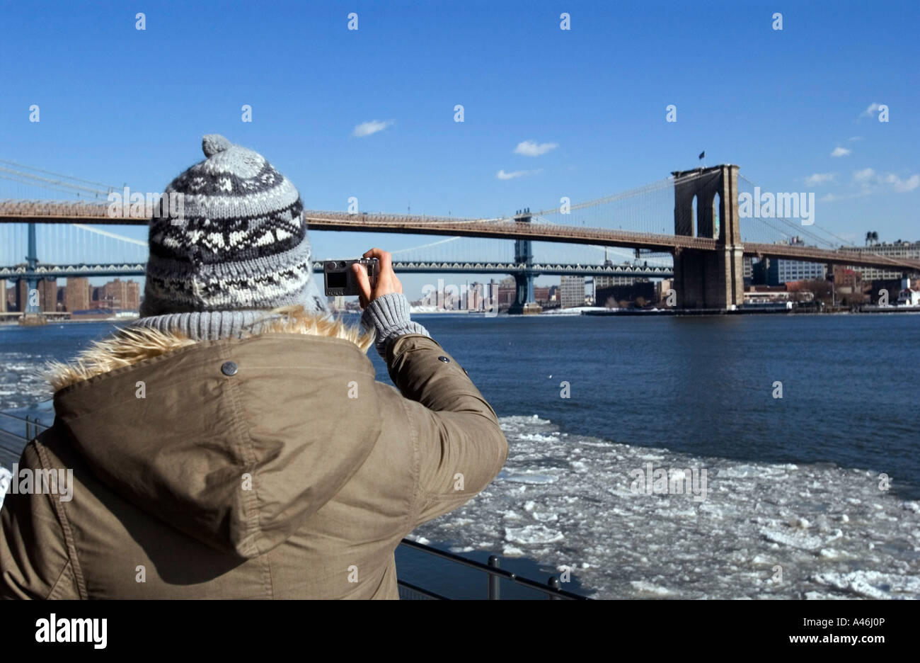 Tourist taking pictures of Brooklyn Bridge and Manhattan Bridge, New ...