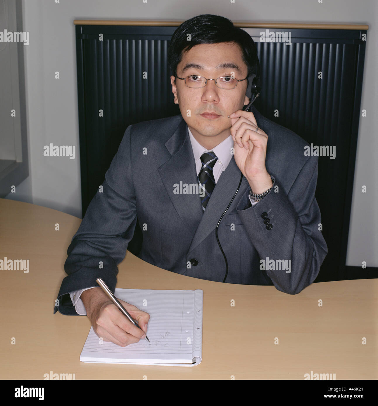 Businessman using telephone headset Stock Photo