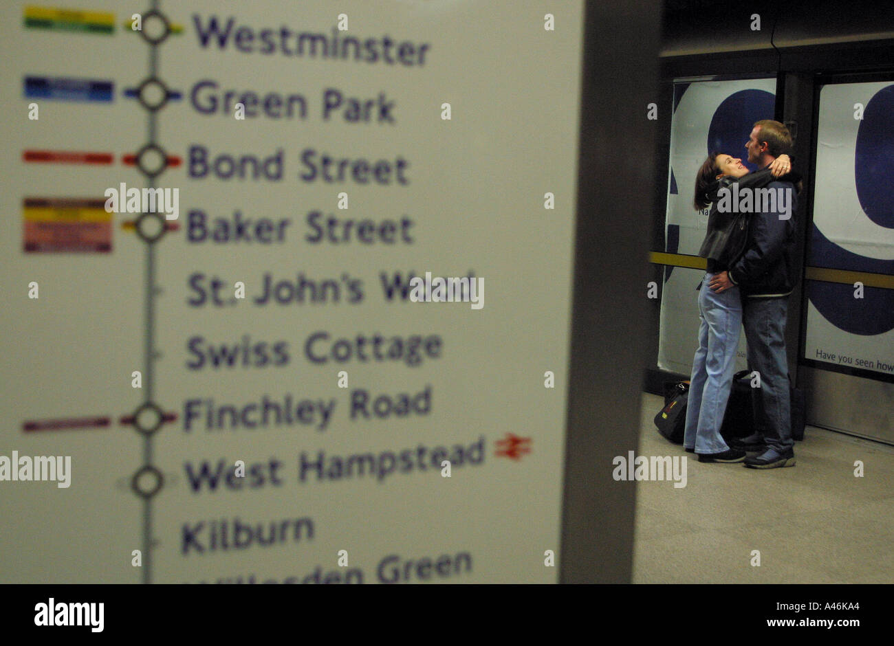 the jubilee underground line in london a couple embrace while they wait ...