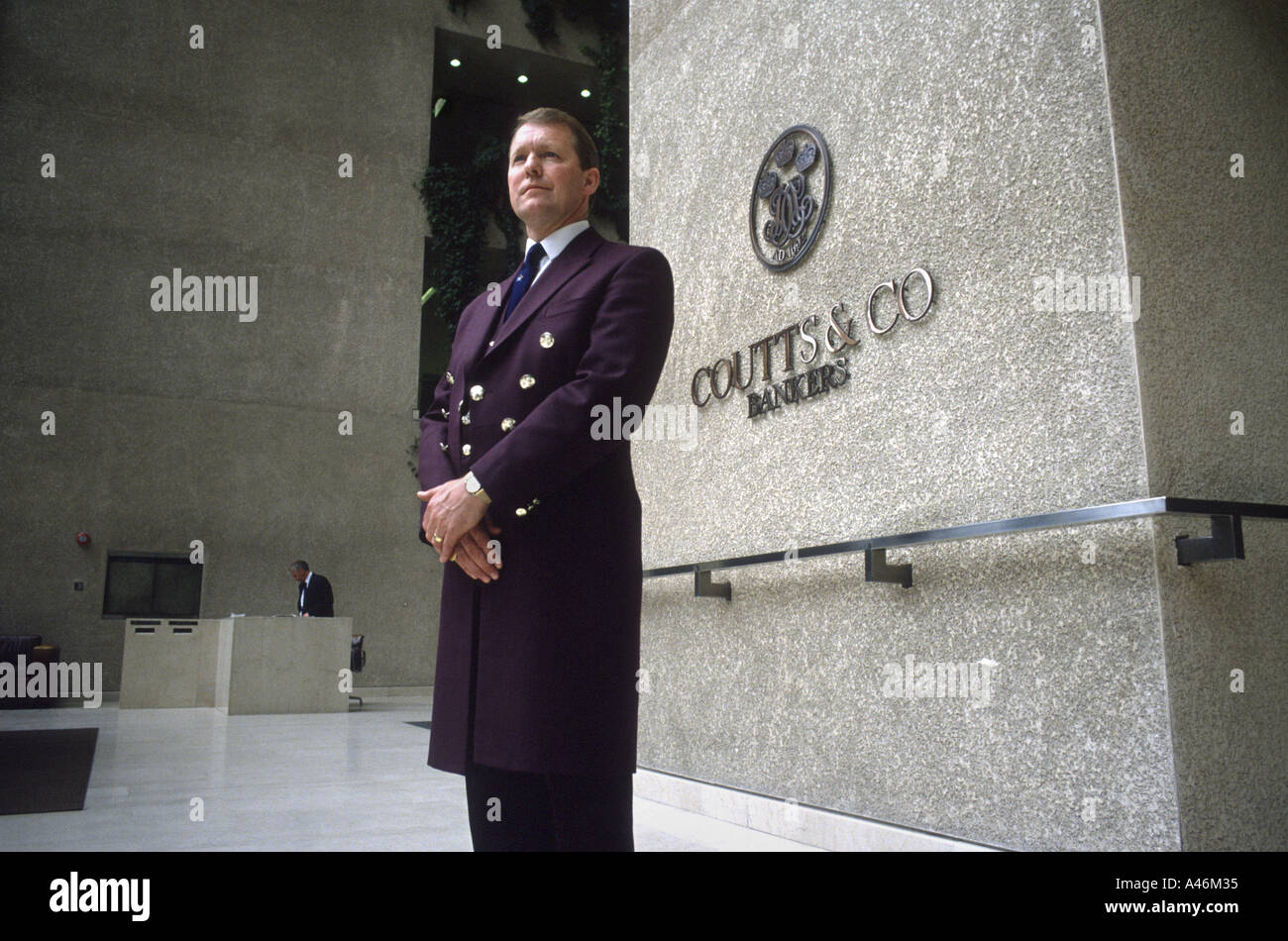 A doorman stands at the entrance to Coutts Bank on the Strand in London. Stock Photo