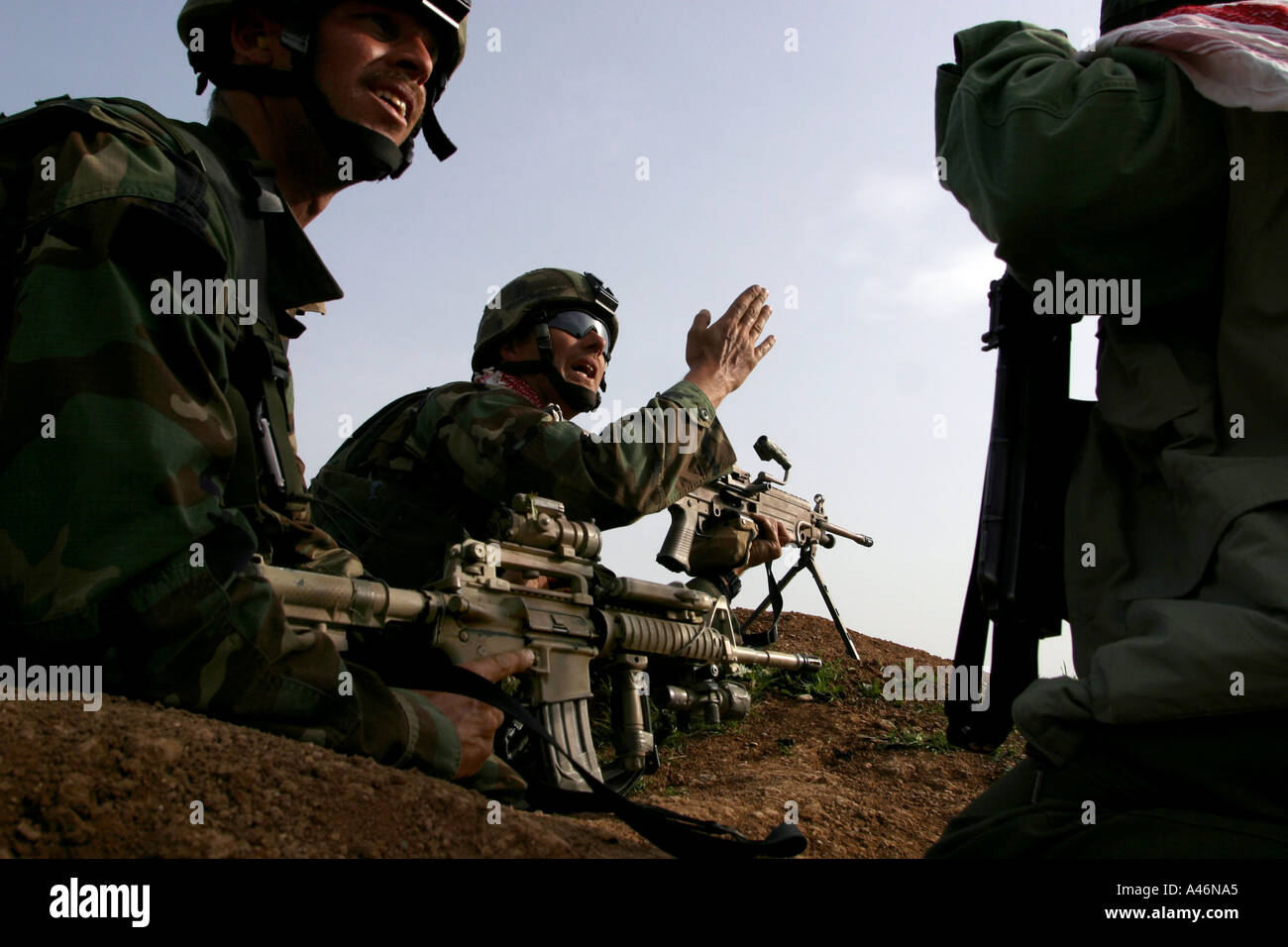 A US Special Forces soldier shouts orders to a Kurdish peshmerga fighter Stock Photo