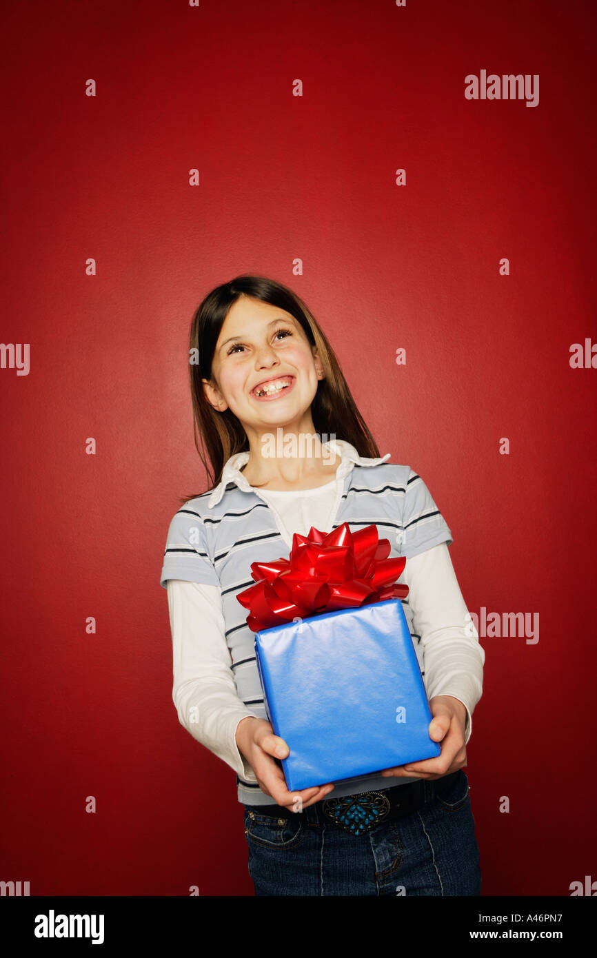Girl holding present Stock Photo - Alamy