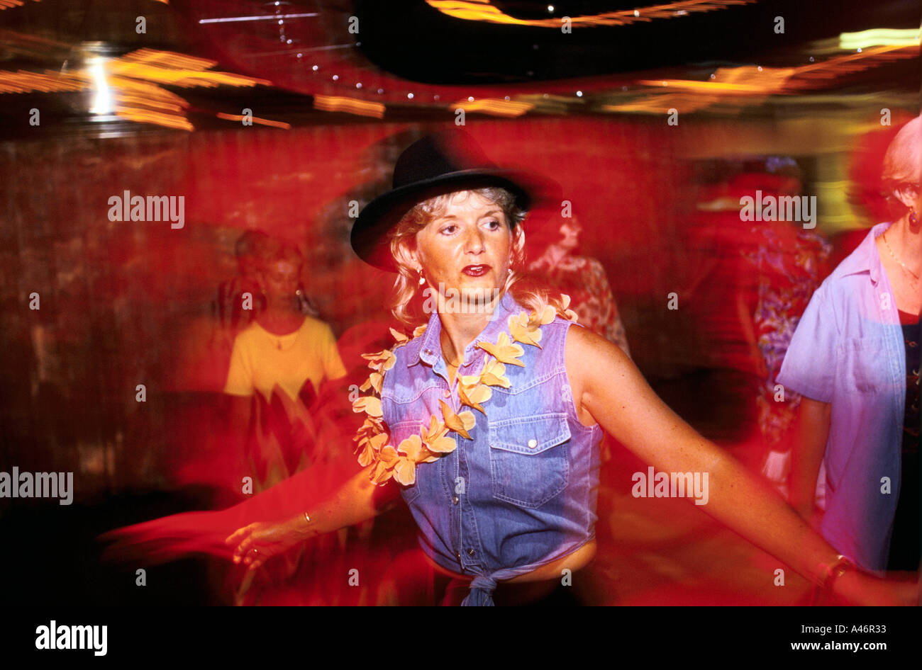 A woman in a stetson dances at a line dancing class on board the Oriana