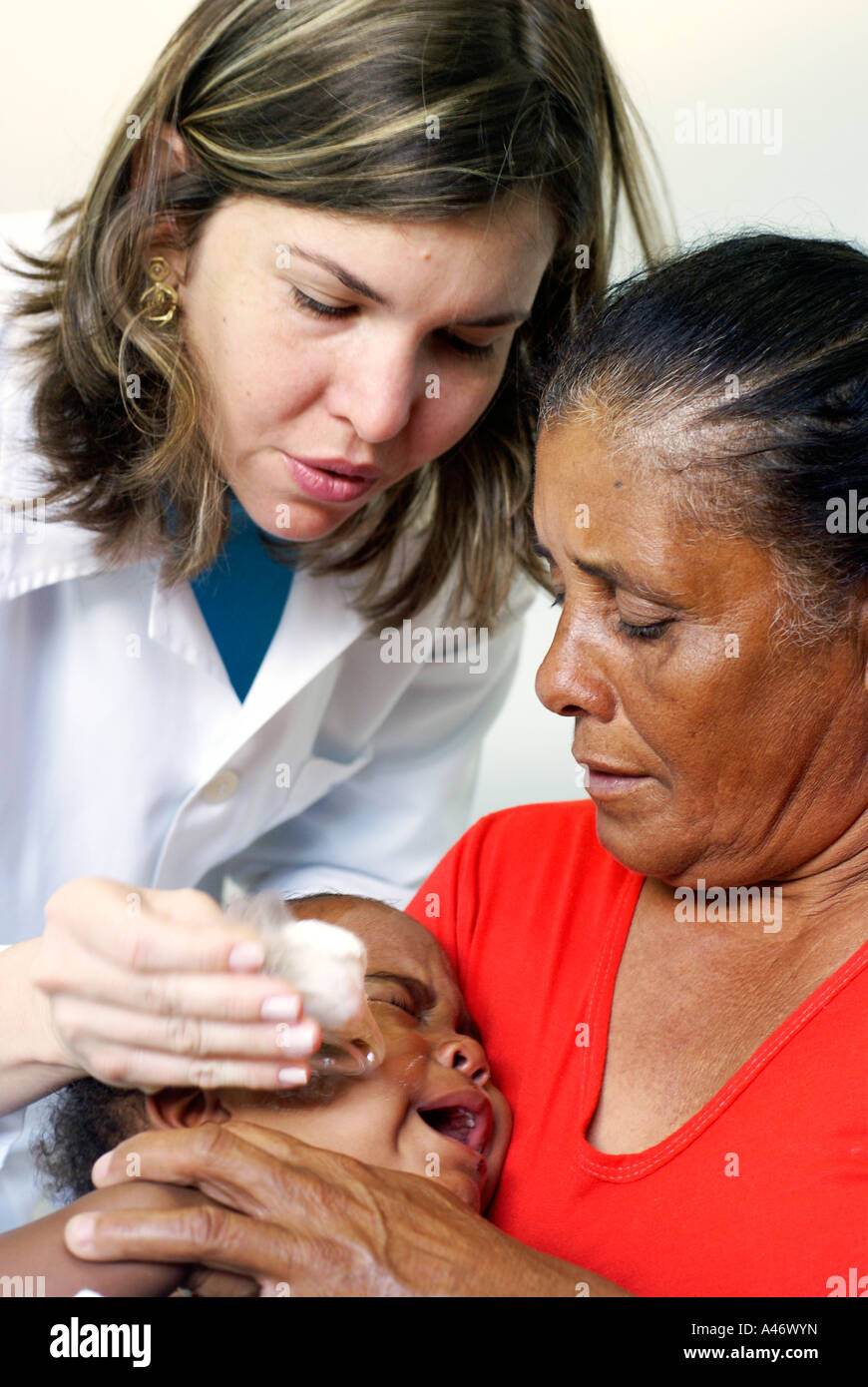 Lifting of the eye patch after a successful cataract operation on a small girl, Recife, Brazil Stock Photo