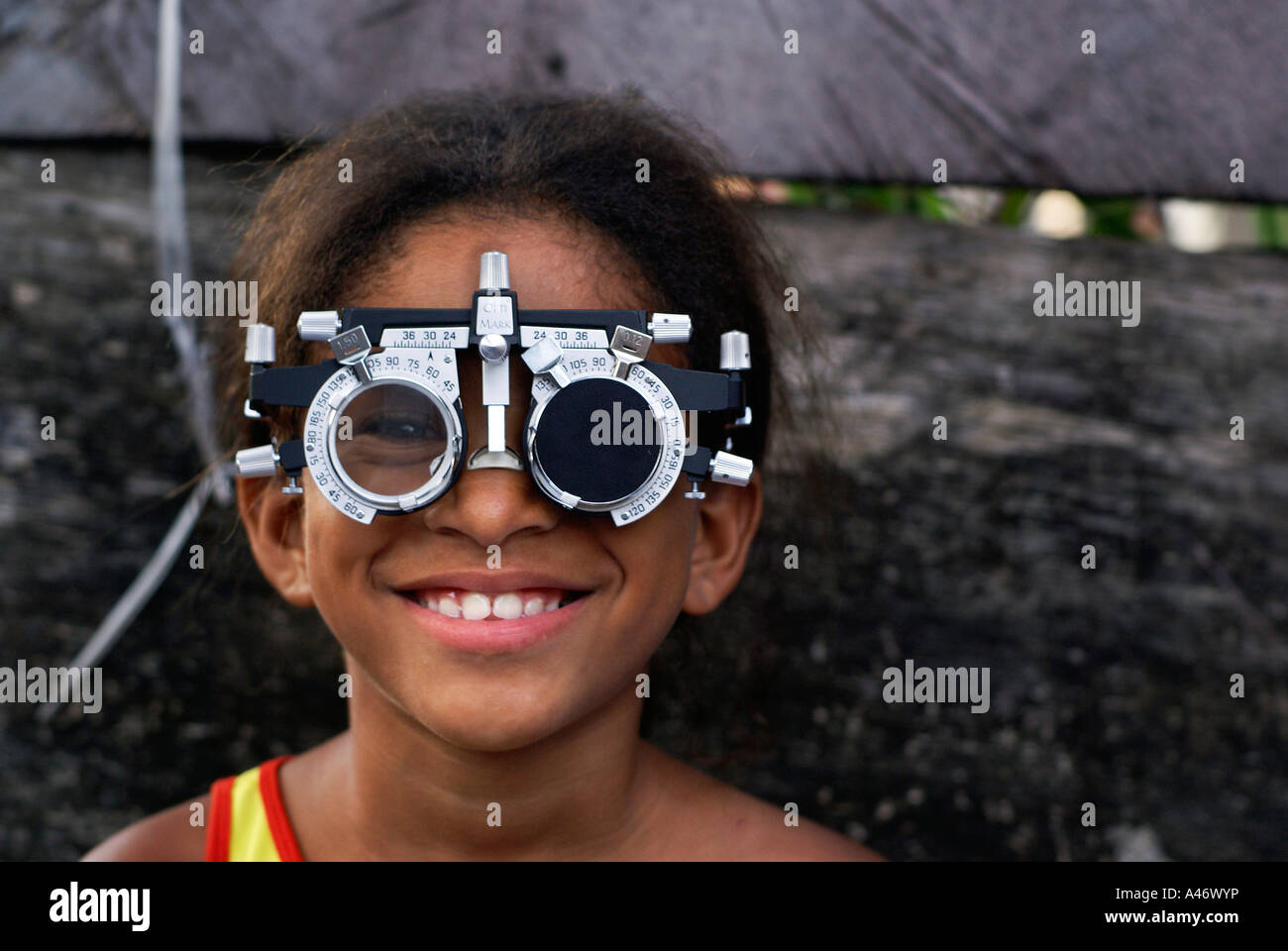 Girl with an instrument for eye examinations in Imbiribeira slum (favela), Recife, Brazil Stock Photo