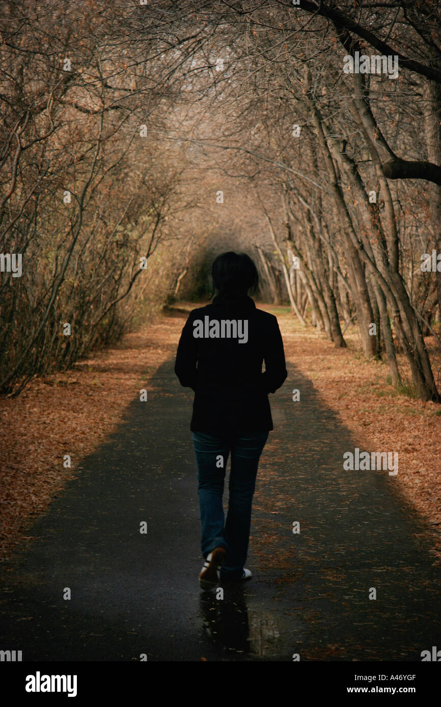 Woman alone on pathway hi-res stock photography and images - Alamy