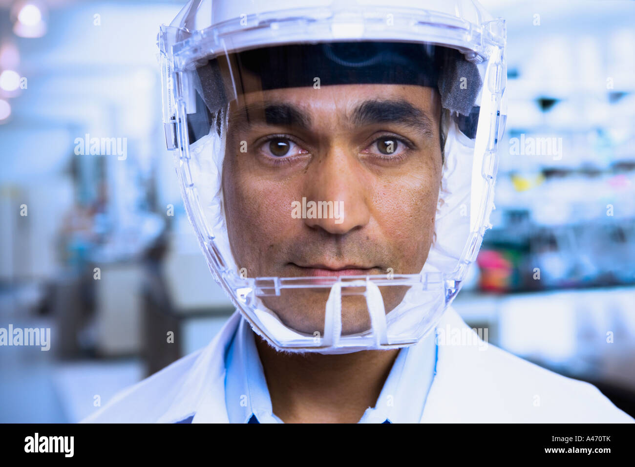 Close up of Indian male scientist wearing respirator Stock Photo