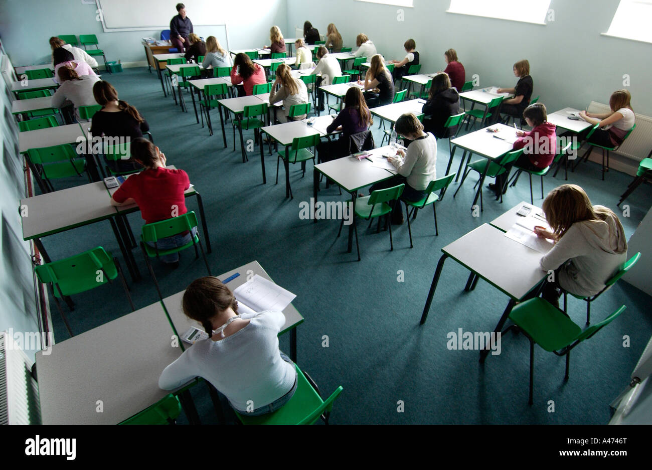 Seen From Above Schoolgirls Taking An Exam In Rows Of Desks Stock