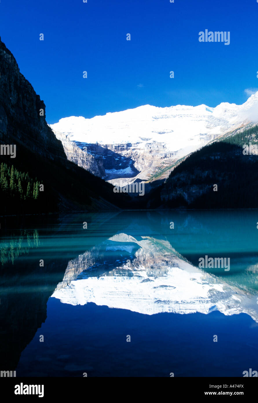 snow capped peaks on the canadian rockies reflected on still waters of a glacier lake, Stock Photo