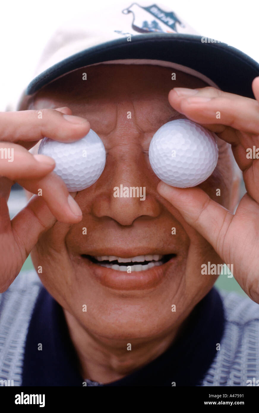 Elderly male golfer with golf ball eyes Stock Photo