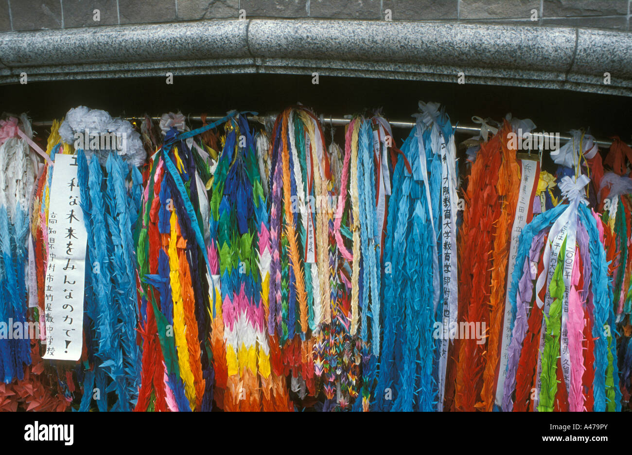 Brightly coloured strings of origami paper cranes hanging at the memorial site where the atom   bomb exploded Nagasaki, Japan Stock Photo