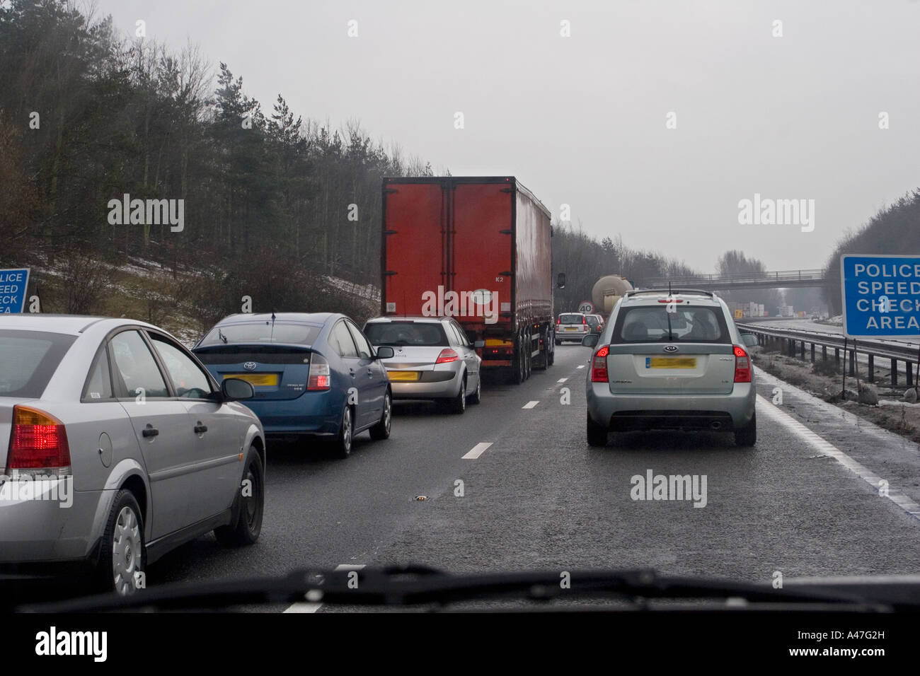 Bad driving conditions in snow and wet weather seen through car