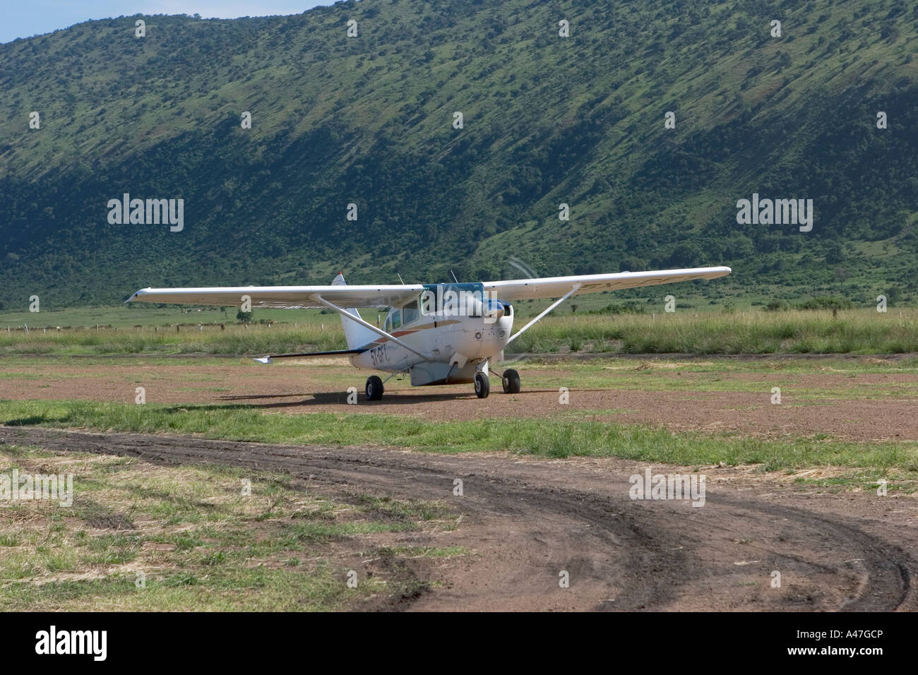 Cessna light aircraft, only easy means of access to area, landing on shores of Lake Albert, Northern Uganda, E Africa Stock Photo