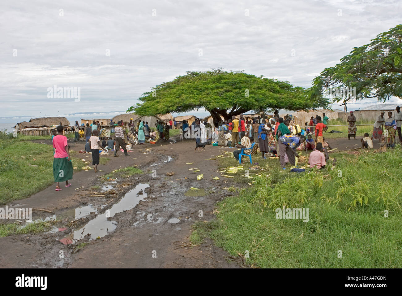 Local people coming from and going to in market of remote fishing village, Lake Albert, Northern Uganda, East Africa Stock Photo