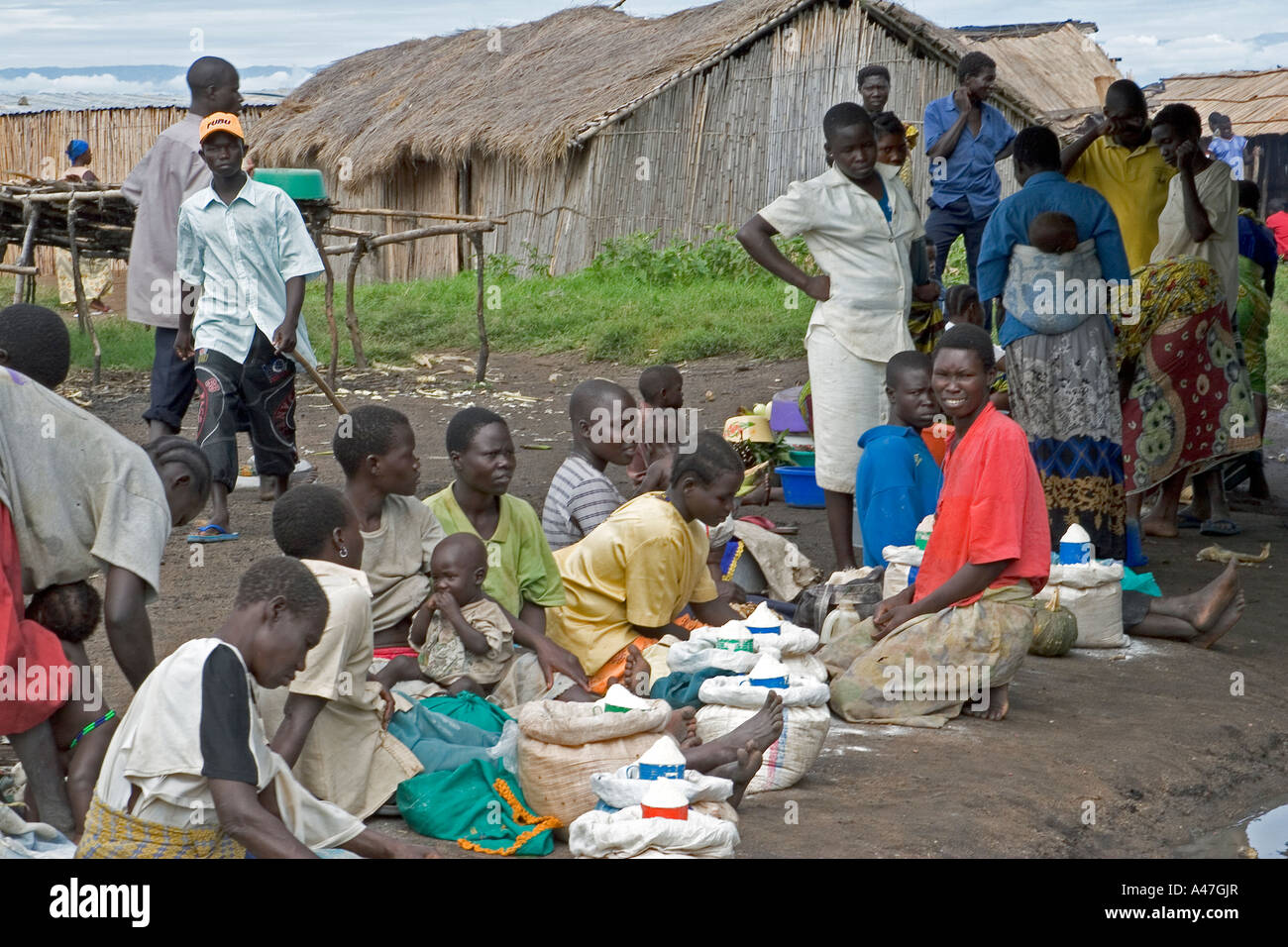 Local women buying and selling in market of remote fishing village, Lake Albert, Northern Uganda, East Africa Stock Photo